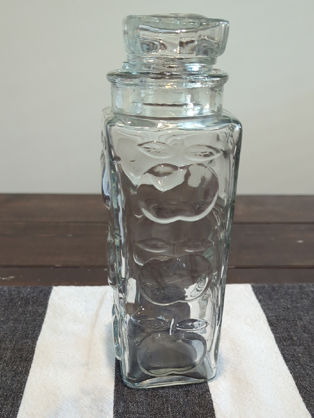 Clear Glass Apothecary Jar with Glass Stopper. Raised Embossed Apple Motif.
